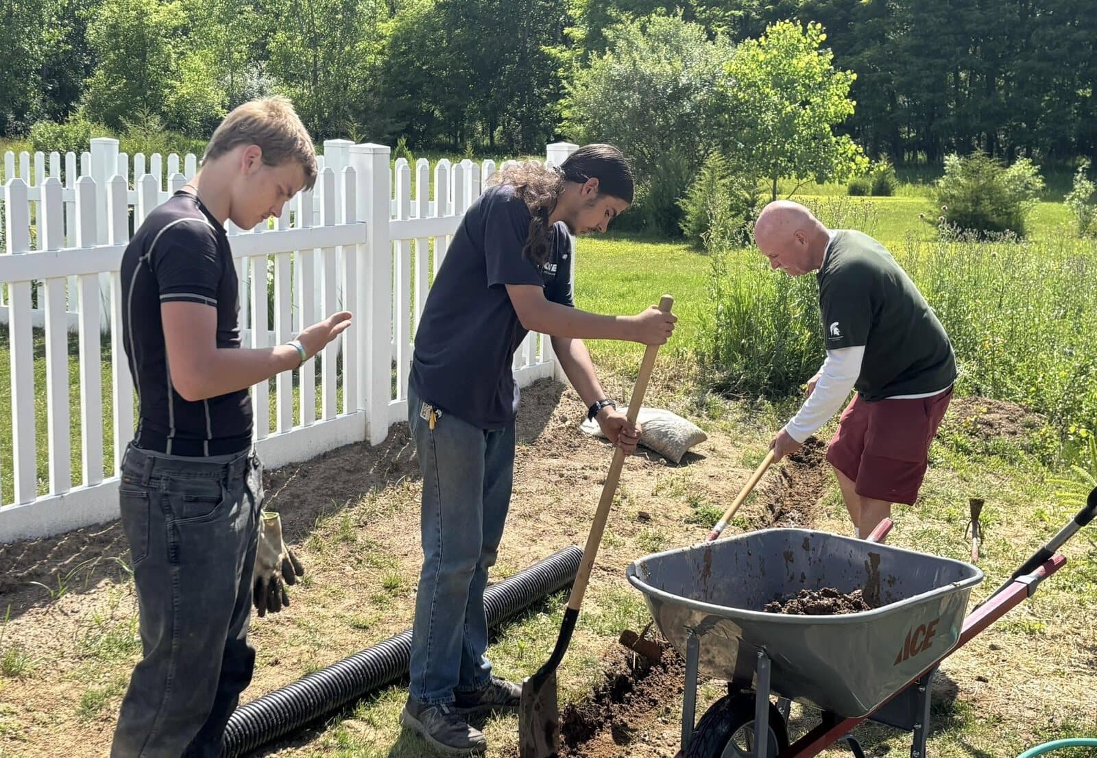 Rise Above students digging a new garden bed together